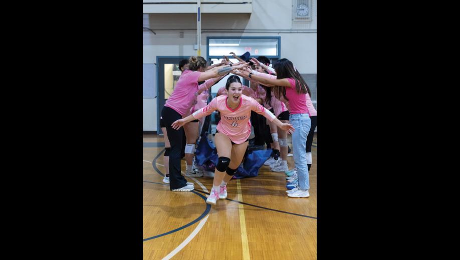 OUT OF THE TUNNEL – Sage Gregg runs onto the court at the start of the Nanooks’ match against Kotzebue during the Arctic Pinkies tournament on Friday, October 16 at Nome-Beltz Middle High School. Photo by Ariana Crockett O’Harra