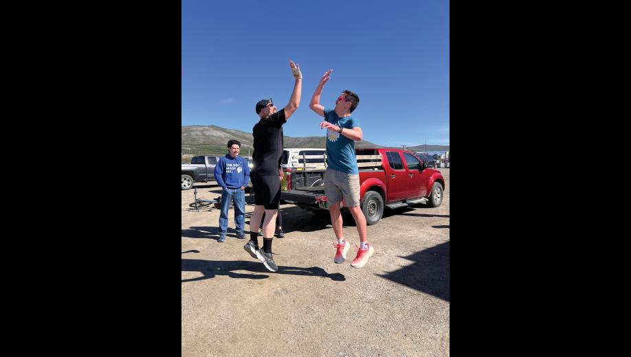 GOOD SPORTS— Rolland Trowbridge and Harrison Moore high-fived after completing the Stroke-n-Croak triathlon, as swimmer Lathen Ahmasuk looks on. Photo by Diana Haecker