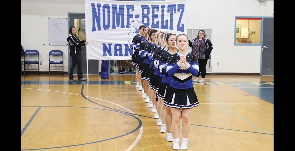 Photo by Anna Lionas Nome-Beltz cheerleaders line up to welcome the Nanook boys onto the court Saturday night.