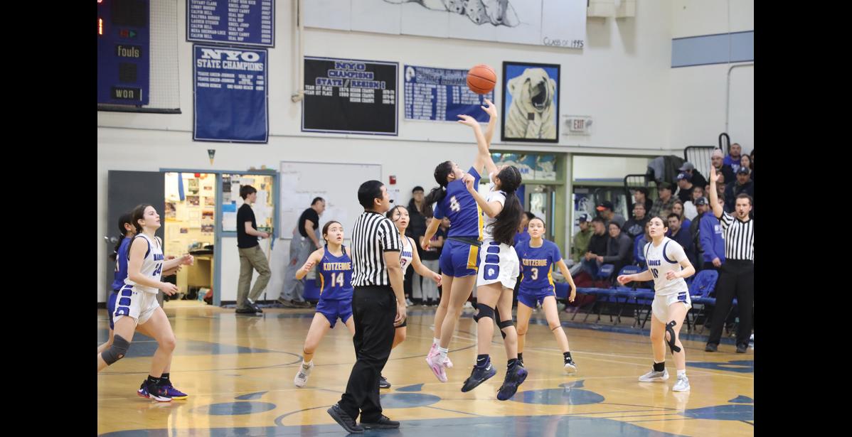Photo by Anna Lionas AwaLuk “Wookie” Nichols of Nome and Ashlyn Nelson of Kotzebue go for the jump ball.