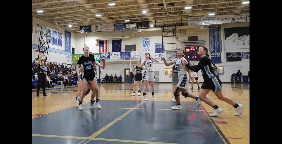 Photo by Anna Lionas Nanooks and Buccaneers watch to see if Nercyn “Benny” Lie’s free throw made it in the basket.