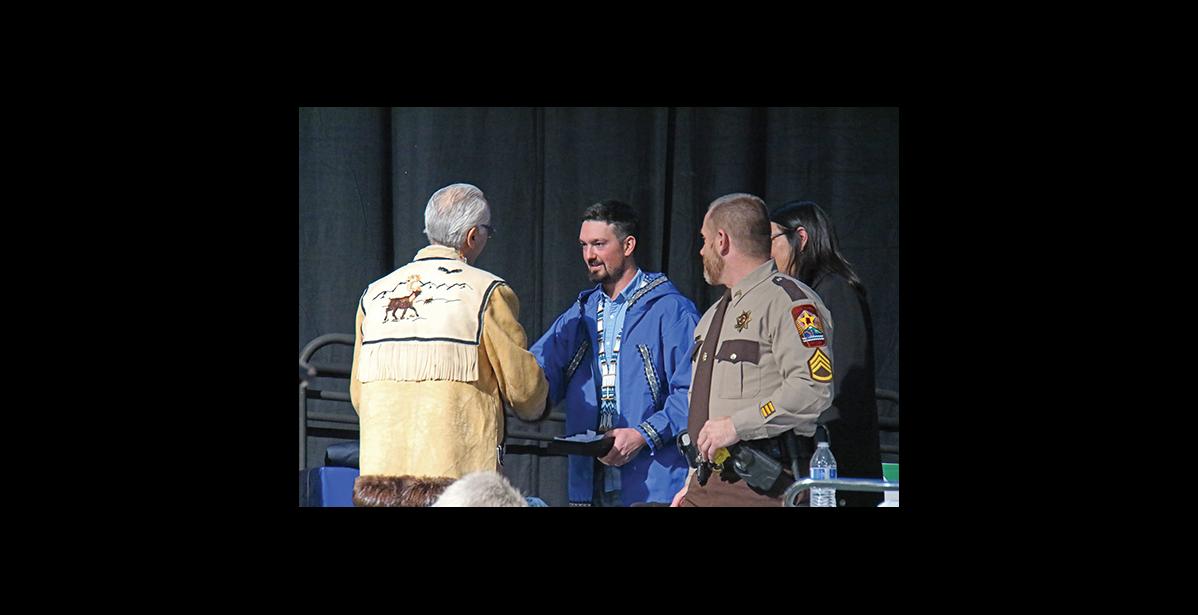 Photo by Julie St. Louis KEY NOTE— Pete Kaiser, 2019 Iditarod champion, receives gifts from Alaska Federation of Natives Co-chairman Will Mayo after his keynote address.