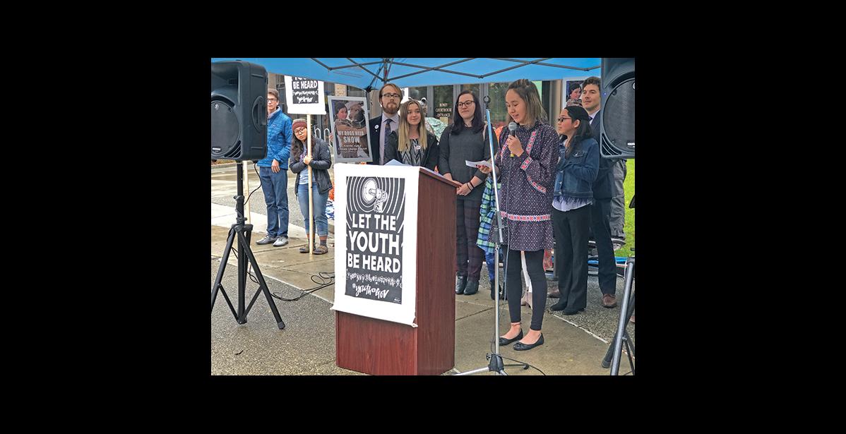 Photo by Julie St. Louis HEAR THE YOUTH—Summer Sagoonick tells the audience gathered outside the Boney Courthouse after a court hearing in Anchorage on Wednesday about climate change impacts on her family and village.