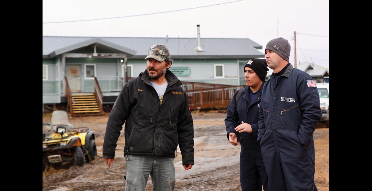 Photo by Jenni Monet Mayor of Golovin Charlie Brown talks with U.S. Coast Guard servicemen on Friday, September 23, 2022 during storm damage cleanup in the community.