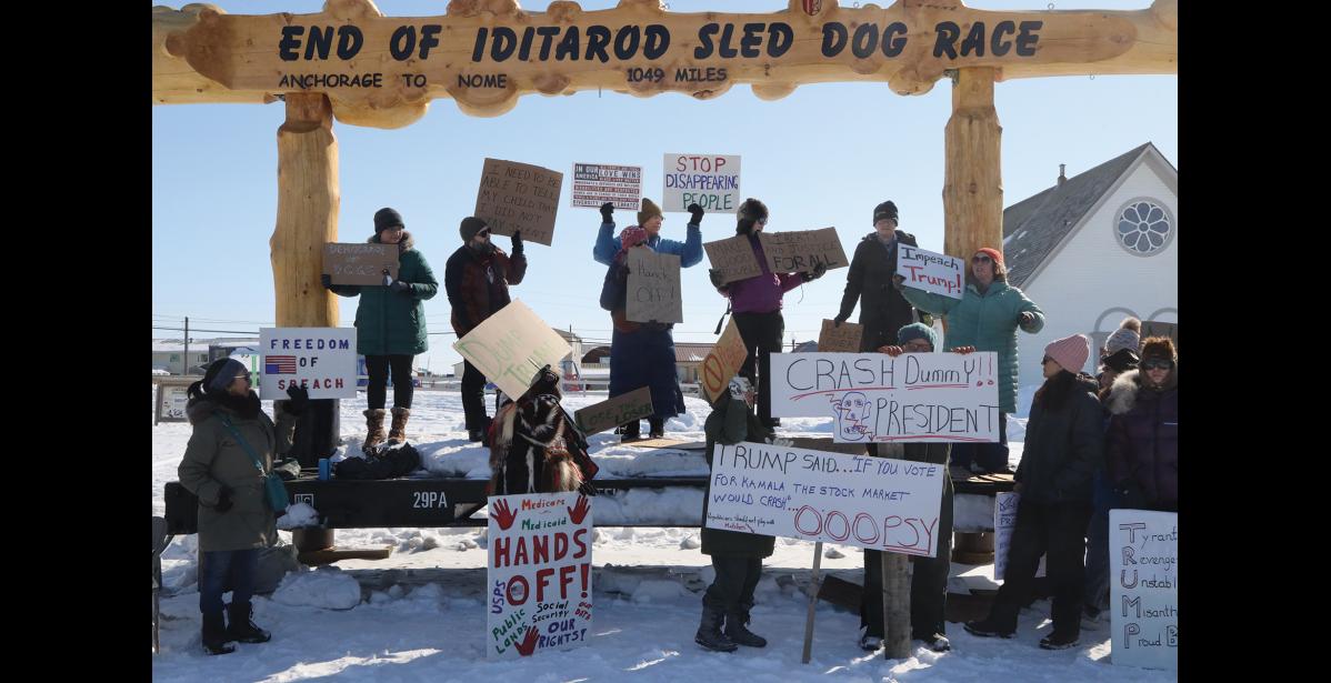 Photo by Laura Robertson HANDS OFF— Nomeites gather at Anvil City Square on Saturday to join nationwide protests against Trump and DOGE.