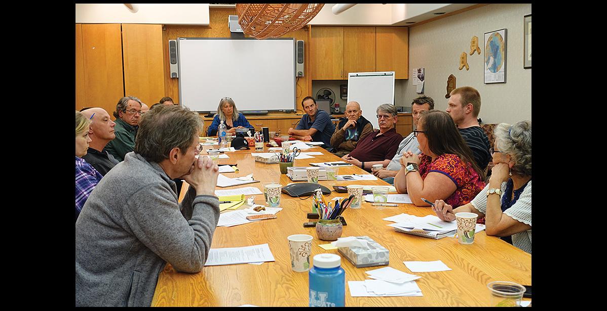 Photo by Maisie Thomas HOUSING CRISIS— Nate Richmond with BlueLine Development, center next to Sue Steinacher and Mayor Richard Beneville, listened to Nome community leaders' discussion of the shortage of low-income rentals in town. He helped to brainstorm solutions during the meeting on July 18.