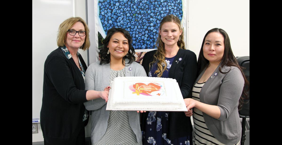Photo by Reba Lean/NSHC GRADUATES—Nursing Instructor Karen Walls, RN joins nurse graduates Mary Ruud, Richelle Horner and Colette Topkok for a picture with their celebratory cake.