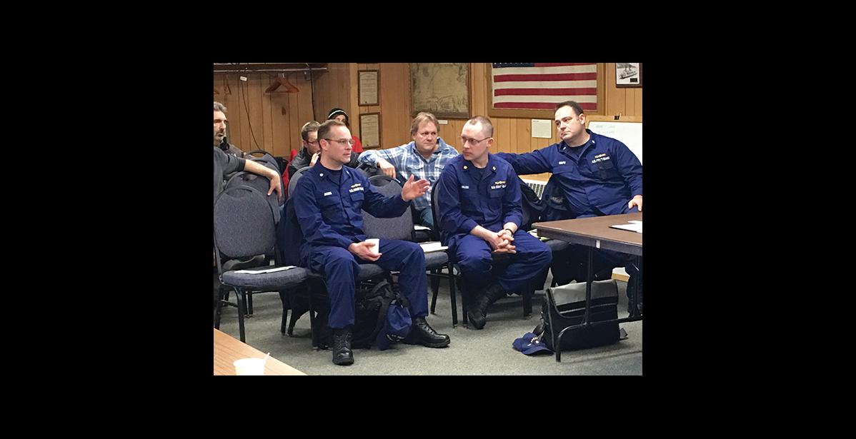 Photo by Sandra Medearis TALKING IT OVER—District 17 U.S. Coast Guard personnel came to Nome to meet with dredge operators who say this season’s enforcement of USCG existing safety regulations will cost lots of money and should not apply to the fleet of “unique” mining dredges. Left to right are Commander Justin Jacobs, Lt. Commander Mason Wilcox, Commander Christopher Coutu.