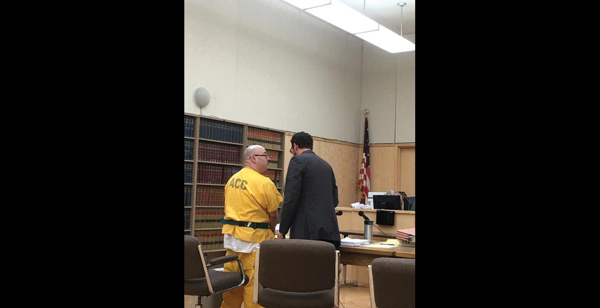 Photo by Sandra Medearis SENTENCING— Frank D. Lee, left, and his defense attorney converse after Lee was sentenced to 80 years for the killing of William Johnson.