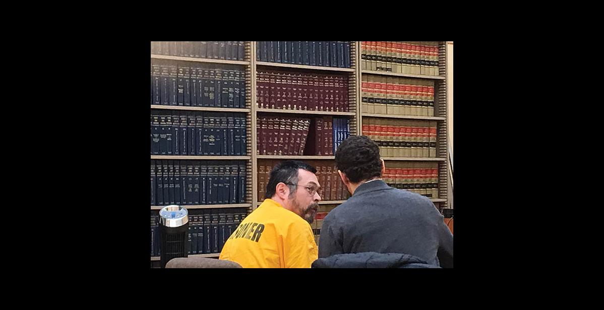 File photo by Sandra L. Medearis CASH SETTLEMENT—Bering Strait School District agreed to pay $12.6 million to victims of sex abuse that parents and students say continued at Wales school. Former school instructor Amos Oxereok, talks with his attorney, James Ferguson, at his sentence hearing Feb. 28 last year in Nome. Oxereok is serving 20 years for sex abuse in the case