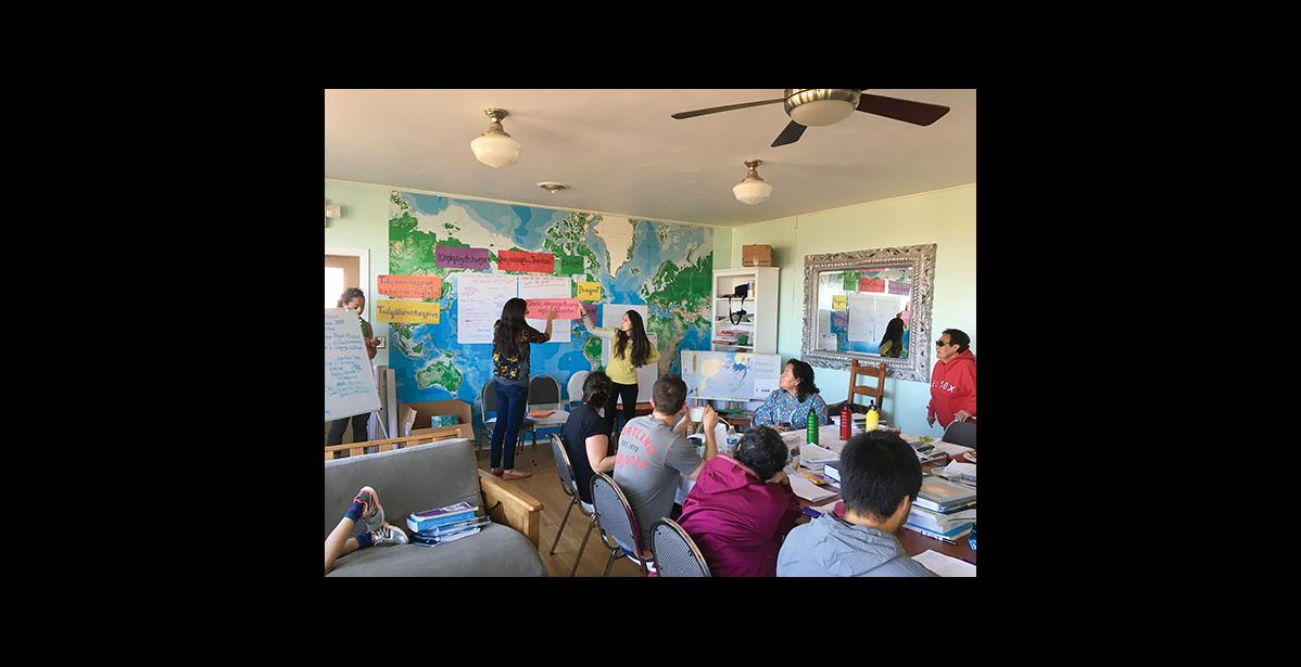 Photo courtesy of Ukallaysaaq Okleasik LEARNING TOGETHER— A two-week language workshop titled Ilisaqativut brought 20 learners of Inuqpiaq to Nome for two weeks. Qunmiġu Kacey Hopson and Annauk Denise Pollock, center, hold a phrase that translates into “How do you write that in Inupiaq?”