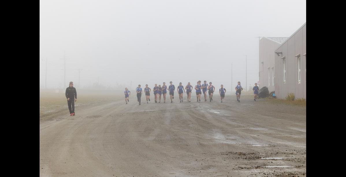 WARMUPS – Members of the Nome-Beltz cross-country running team warm up before the middle school division of the Musk Ox Classic on Saturday, September 5. Photo by Ariana Crockett O'Harra