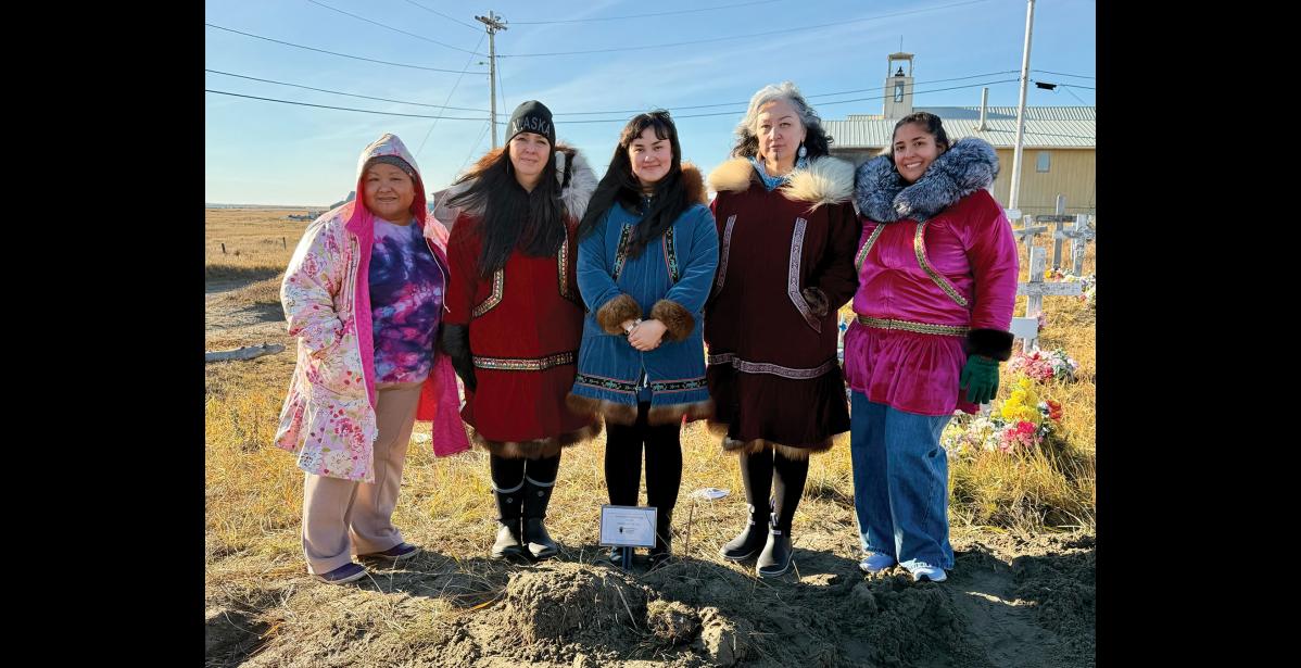 GATHERED – Vanessa Walluk, Rosemary Tower, Nyché Andrew, Jacqueline Agugaq Walluk and Madeline Gupta next to Tummassak’s grave in Shishmaref. Photo courtesy of Nyché Andrew