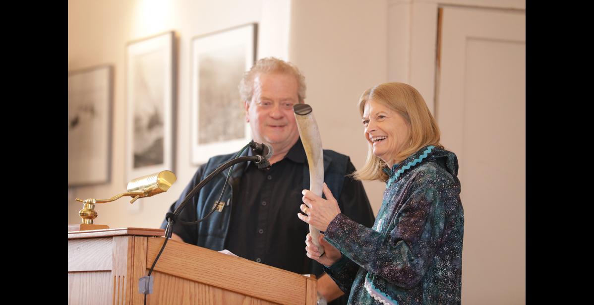 Photo by Diana Haecker PRESENT— With a uniquely Nome-sense of humor, Nome Mayor John Handeland gifted Senator Lisa Murkowski with an oosik, the private parts of a male walrus, as an appropriate tool to take back to Congress.