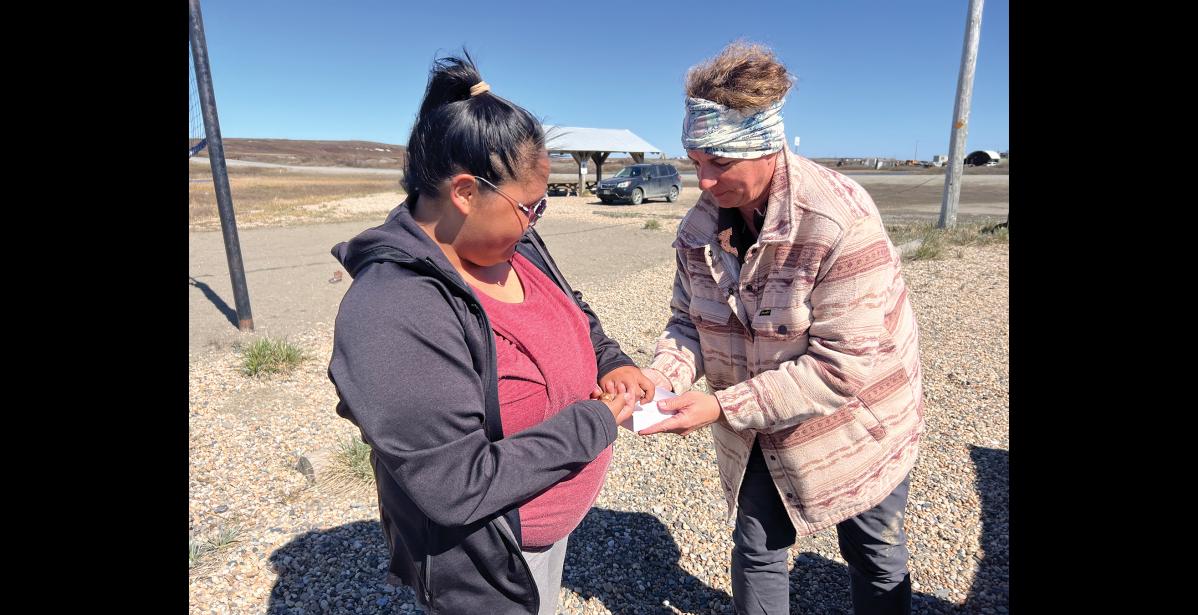 Photo by Diana Haecker Zona Fitka brings by some eggs for Dr. Lisa Kercher of St. Jude's Children's Hospital, who conducted testing in Nome for avian flu.