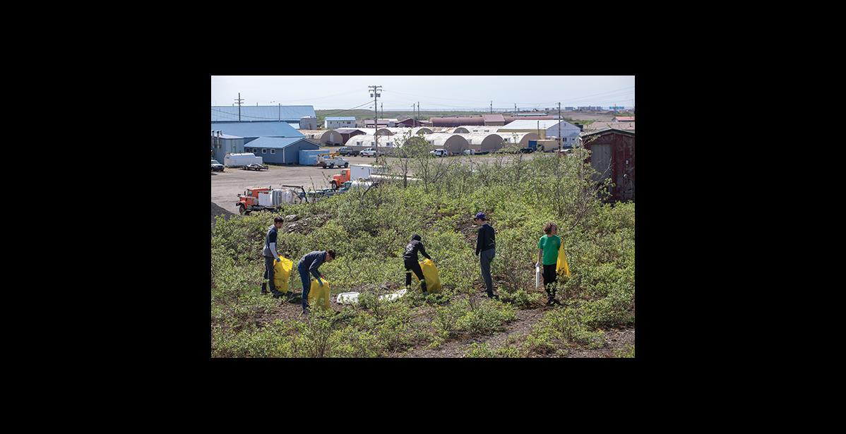 Photo by James Mason CLEANUP – Lisa Leeper, right, and her crew of clean uppers pick up trash across the Teller Road from Nome-Beltz High School Saturday.