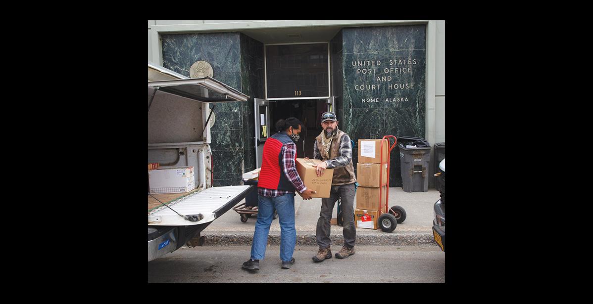 Photo by James Mason COURT MOVE— Kekai Newman, left, and Bryce Rickers with Drake Construction transfer boxes of courthouse property to a pickup for transport to the new location as the Court moved last week to a temporary location at the Lutheran Church before it will relocate to its new permanent home at the old hospital.