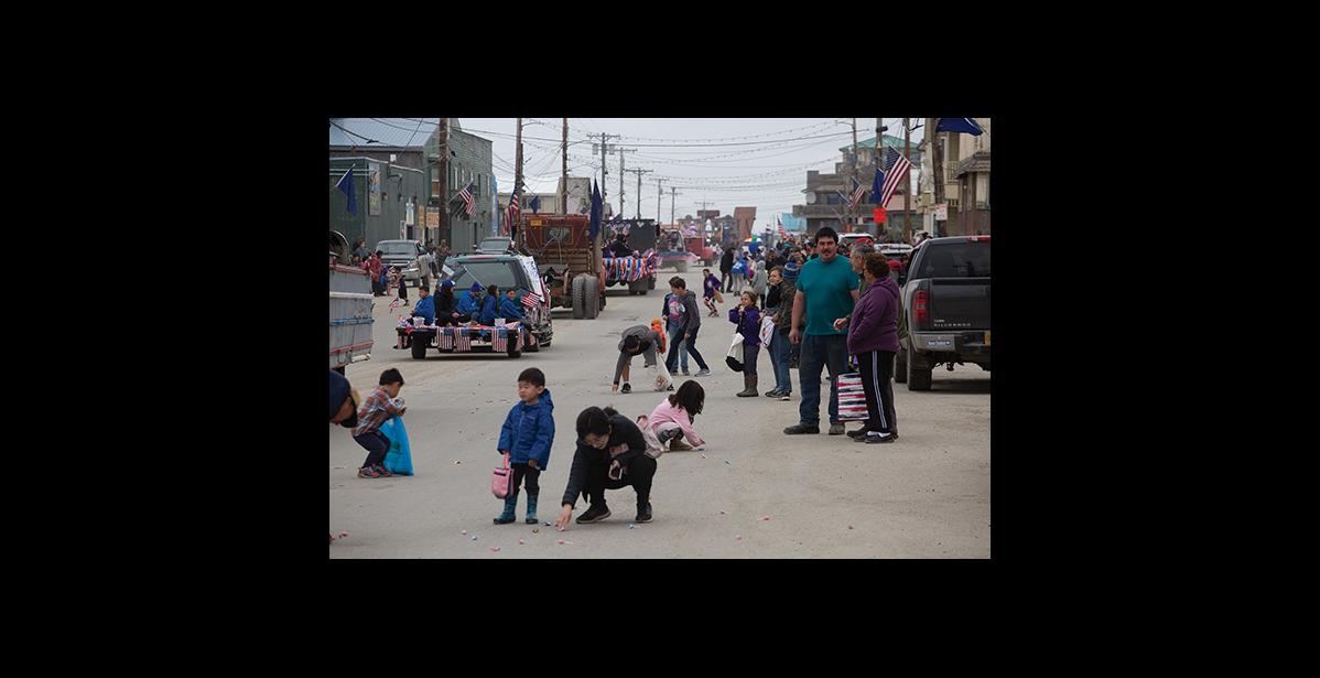 Photo by James Mason PARADE SCRAMBLE— Kids grabbed at the candy tossed from vehicles as the Nome Fourth of July parade made its way down Front Street Saturday.