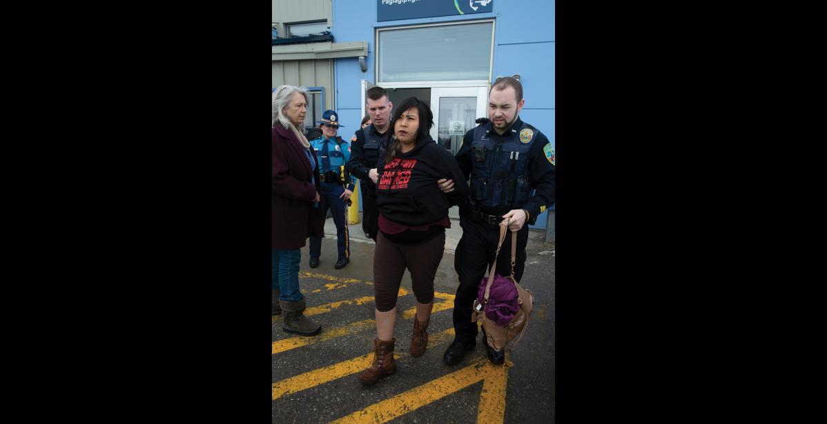 Photo by James Mason Brenda Evak being arrested for disorderly conduct, at the Alaska Airlines terminal in Nome, on March 27, 2019.