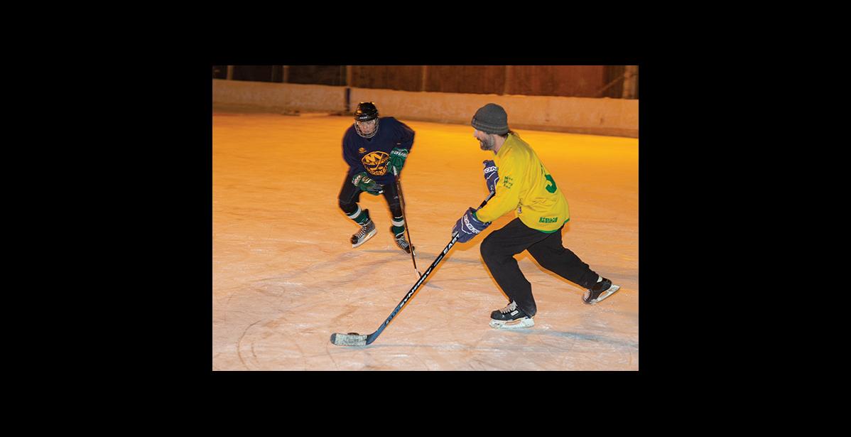 Photo by James Mason HOCKEY – Two hockey players enjoy the ice Friday on the Nome ice rink.
