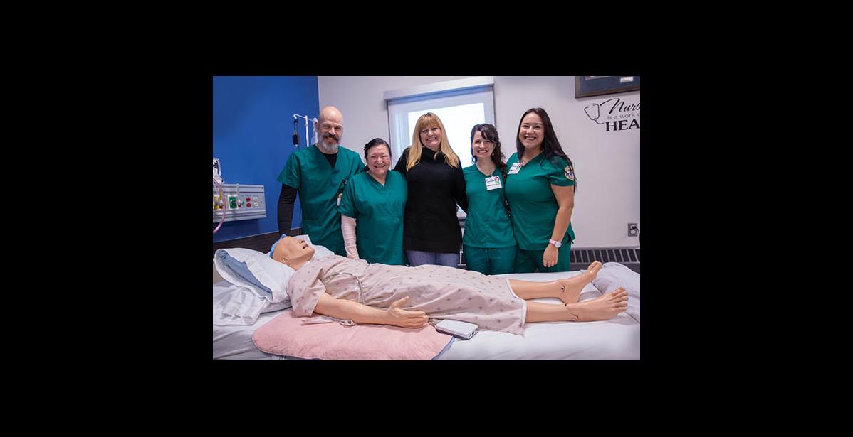 Photo by James Mason FUTURE NURSES – The current cohort of nurses-to-be and their instructor get their picture taken with their favorite patient. From left are Daniel Hobbs, Veronica Verbridge, RN and instructor Wendy Smith, Vanessa Tahlhofer and Kallie King.