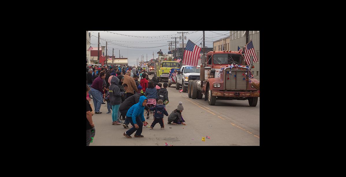 Photo by James Mason FOURTH OF JULY PARADE – Kids scramble for candy as the floats drift by during Nome’s Fourth of July parade.