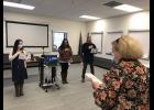 Photo courtesy NSHC ITS OFFICIAL— Nursing instructor Flo Kassly leads graduates Alyse Morris, Kallie King, Daniel Hobbs and their remotely participating classmates in an oath as part of their graduation ceremony.