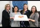 Photo by Reba Lean/NSHC GRADUATES—Nursing Instructor Karen Walls, RN joins nurse graduates Mary Ruud, Richelle Horner and Colette Topkok for a picture with their celebratory cake.