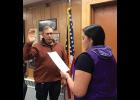 NVESTIGATOR— Detective Michael Heintzelman has taken a temporary full-time job with Nome Police Dept. as a full-time investigator to help clear a backlog of cases. Here, Christine Piscoya, deputy city clerk, administers Heintzelman’s oath of office. 