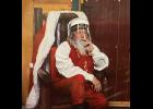 Photo courtesy Paul Kudla SANTA SOCIAL DISTANCES—While working as a professional Santa Claus in Anchorage, Nome’s Santa a.k.a. Paul Kudla must wear a face shield and sit behind a glass wall.