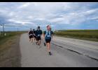 DRAFTING— Tyler Rhodes leads the Anvil Mountain Run outbound at the Nome-Teller Highway. Behind him is Tobin Hobbs, Oliver Hoogendorn, Nicholai Olson and two unidentified runners. Photo by Ariana Crockett O’Harra