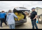 Photo by Ariana Crockett O'Harra HAULING TRASH— Rachel Ventress, left, unloads her car with the help of Patty Burchell, center, and City Manager Lee Smith in the Old St. Joe’s parking lot at the city’s spring cleanup on Saturday, June 6.