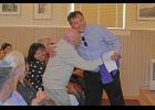 Photo by Diana Haecker Richard Beneville gives Jake Kenick a hug during a celebration of Beneville's contributions to Nome last year at Old St. Joe's.