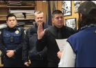 Photo by Sandra Medearis New NPD officer Vingent Nguyen is sworn in by City Clerk Bryant Hammond as NPD Chief Bob Estes and officer Alex Le look on.