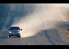 Photo by James Mason RAISING DUST – A pickup truck on Greg Kruschek Avenue raises a cloud of dust. With no snow yet Nome is a dusty place.