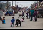 Photo by James Mason PARADE SCRAMBLE— Kids grabbed at the candy tossed from vehicles as the Nome Fourth of July parade made its way down Front Street Saturday.