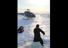 Photo courtesy U.S. Fish and Wildlife POLAR BEAR STUDIES— U.S. Fish and Wildlife Service biologist Michelle St. Martin takes measures on an adult female polar bear captured on sea ice west of the Red Dog Mine Port site.